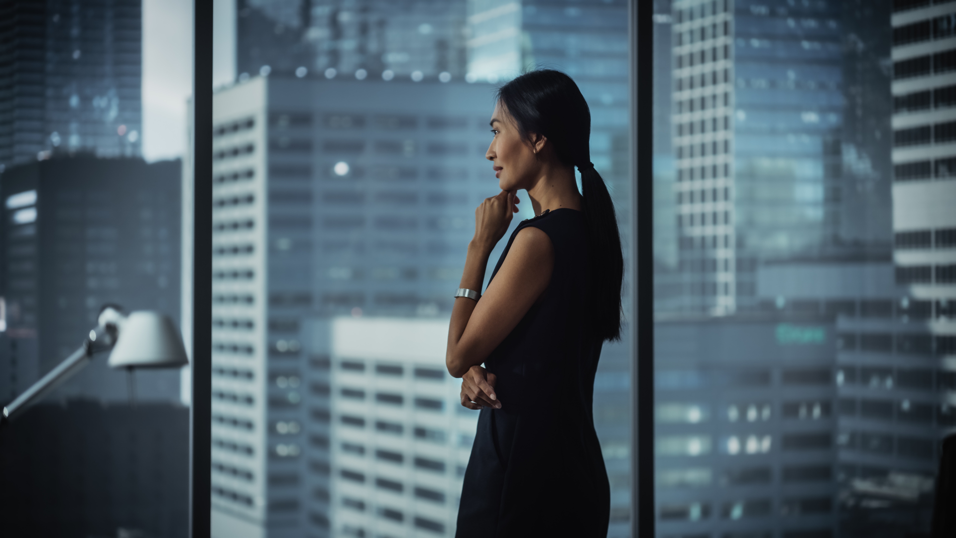 Executive leader at a high-rise window overlooking the city